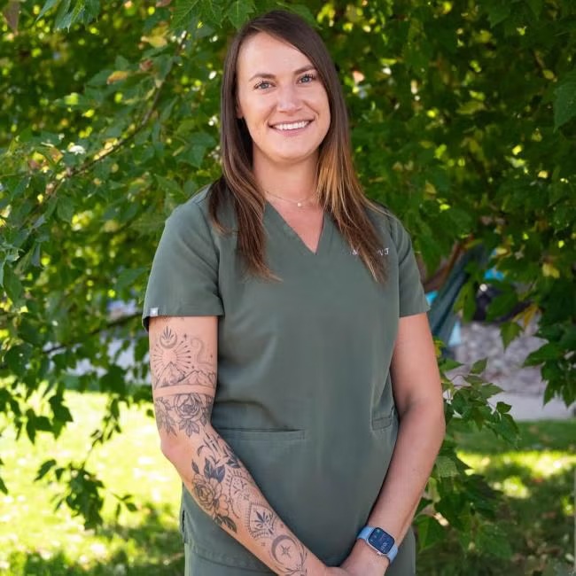 Mel Arnold, registered veterinary technician at Carbondale Animal Hospital, wearing green scrubs 