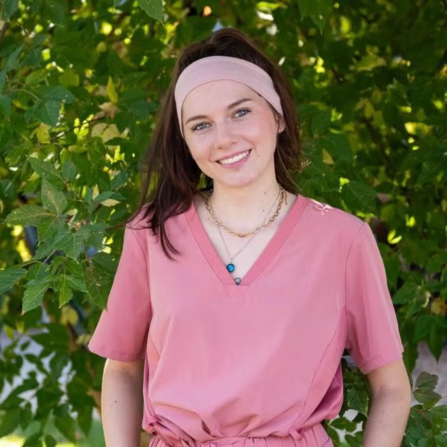 Neva Sunday, registered veterinary technician at Carbondale Animal Hospital, wearing pink scrubs 